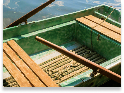 Close Up of a Green Wooden Row Boat in the Water